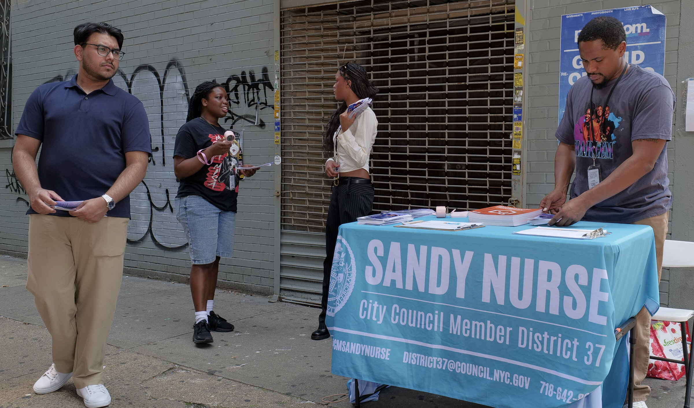 Dominique Alexandre and District 37 interns staffing a constituent pop-up table in Brooklyn