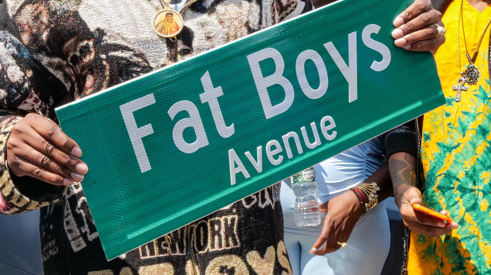 Family members hold the new Fat Boys Avenue street sign at the co-naming ceremony on Schenck Avenue in East New York
