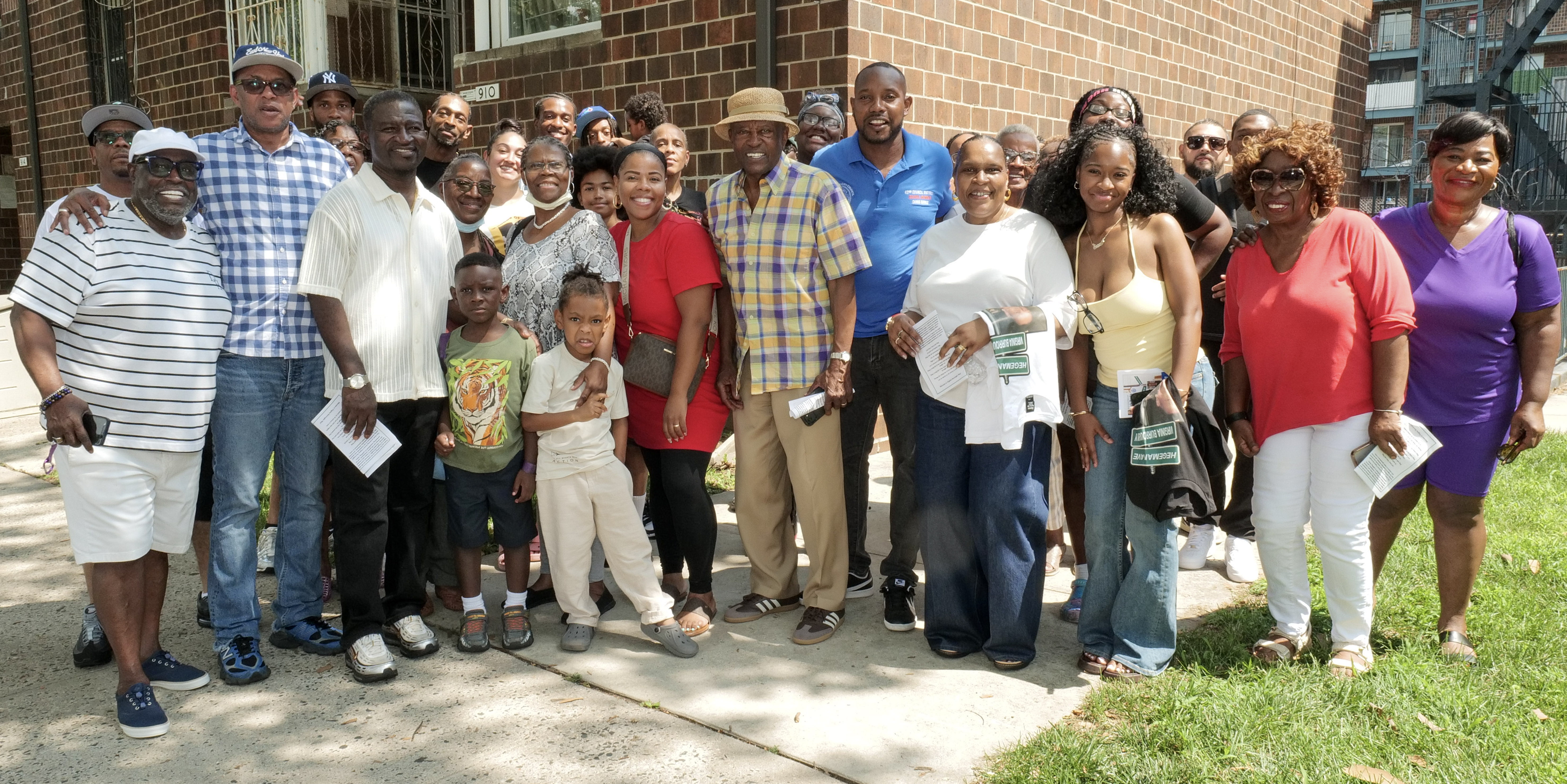 Family, friends and neighbors gather outside Essex Terrace after the Virginia Burroughs Way co-naming ceremony